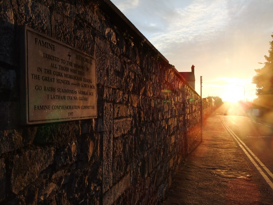 Sunset on Great Famine memorial plaque on the boundary wall of St Finbarr's Hospital, Douglas Road, Cork